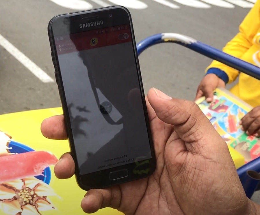 Vendor holding a mobile phone with a tracking app